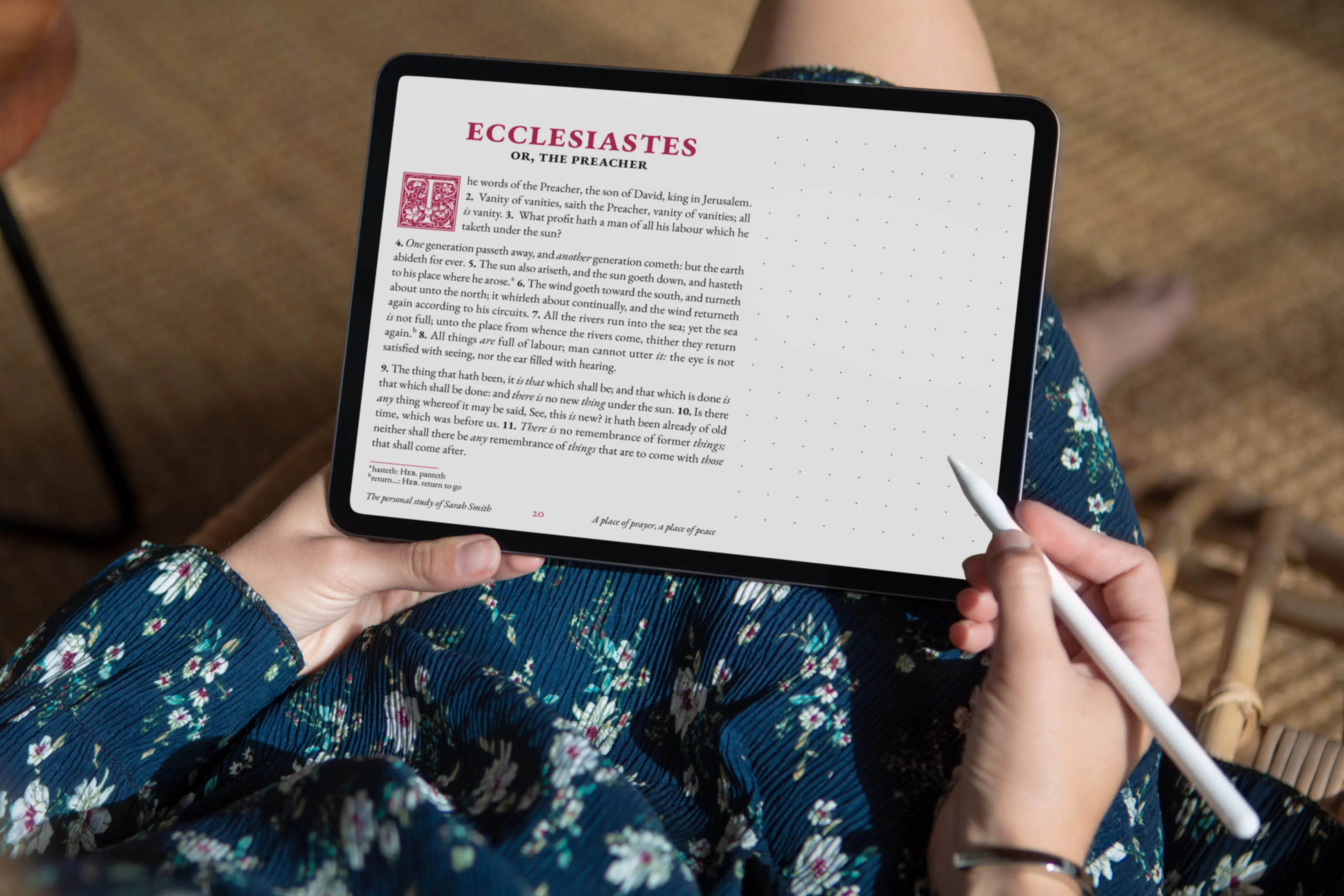 Person reading Personal Edition on tablet with stylus, showing Ecclesiastes with burgundy accents and dotted margin