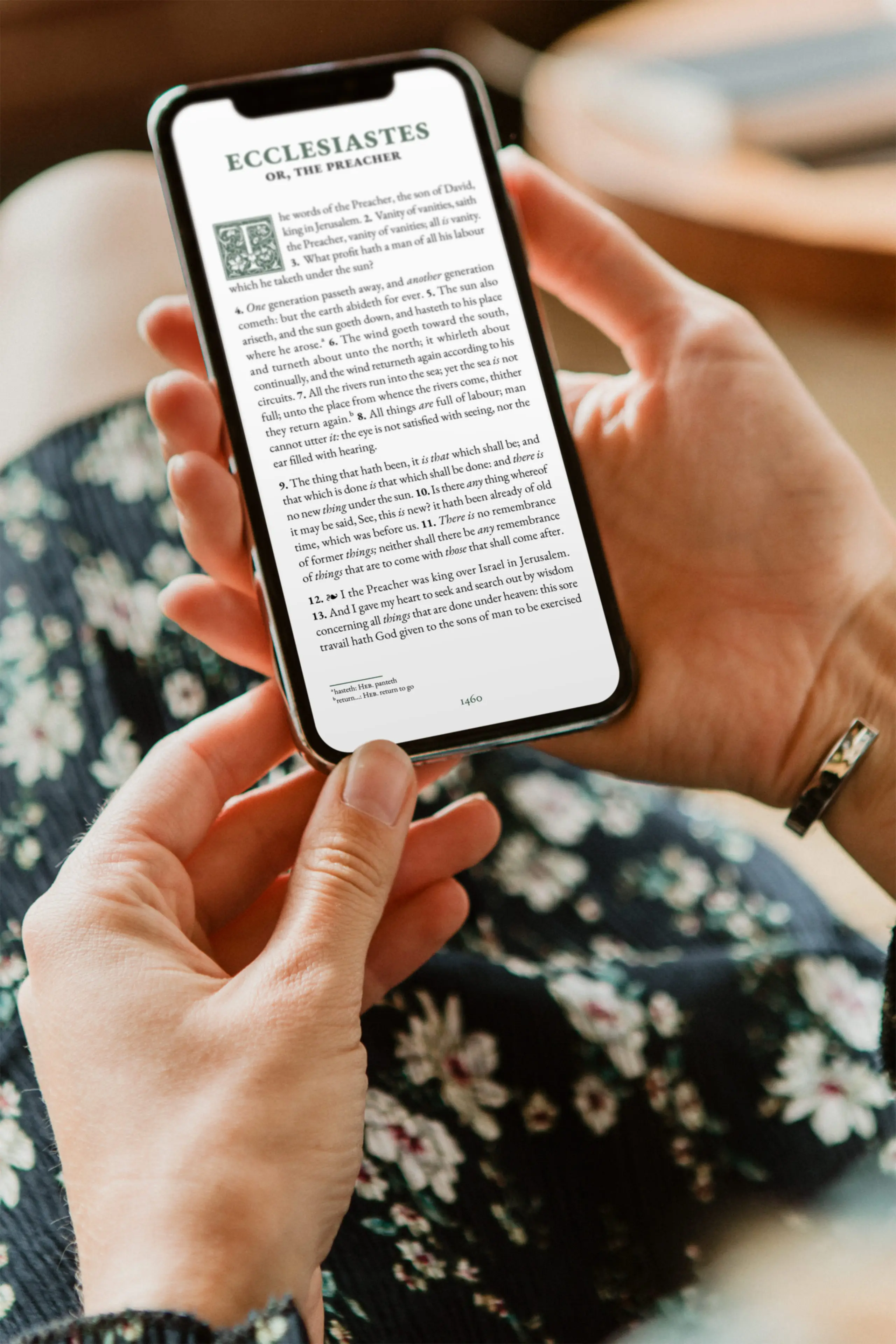 Hand holding smartphone displaying Ecclesiastes from the KJV Digital Bible