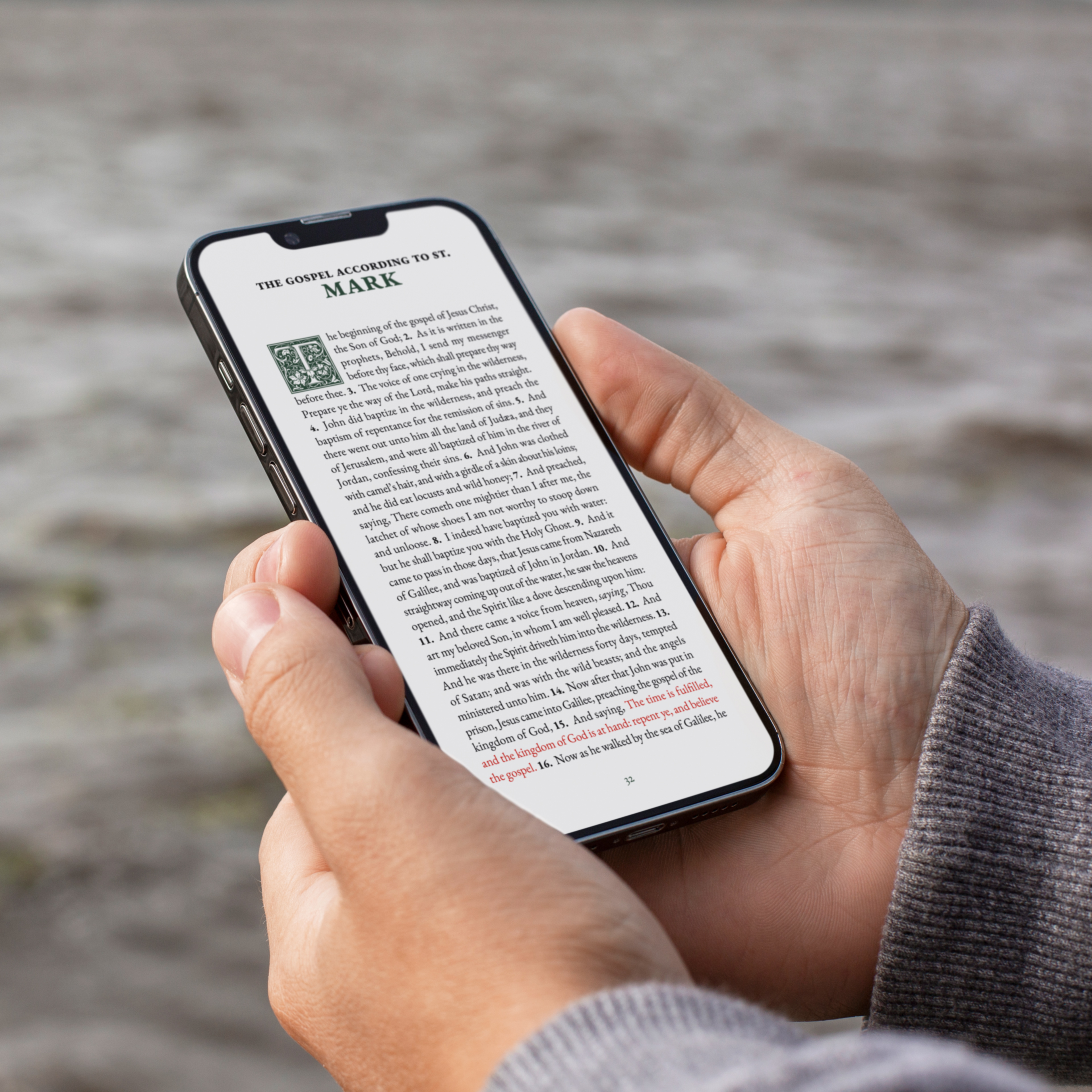 Person reading KJV Digital Bible on smartphone outdoors, showing Gospel of Mark with highlighted words of Jesus